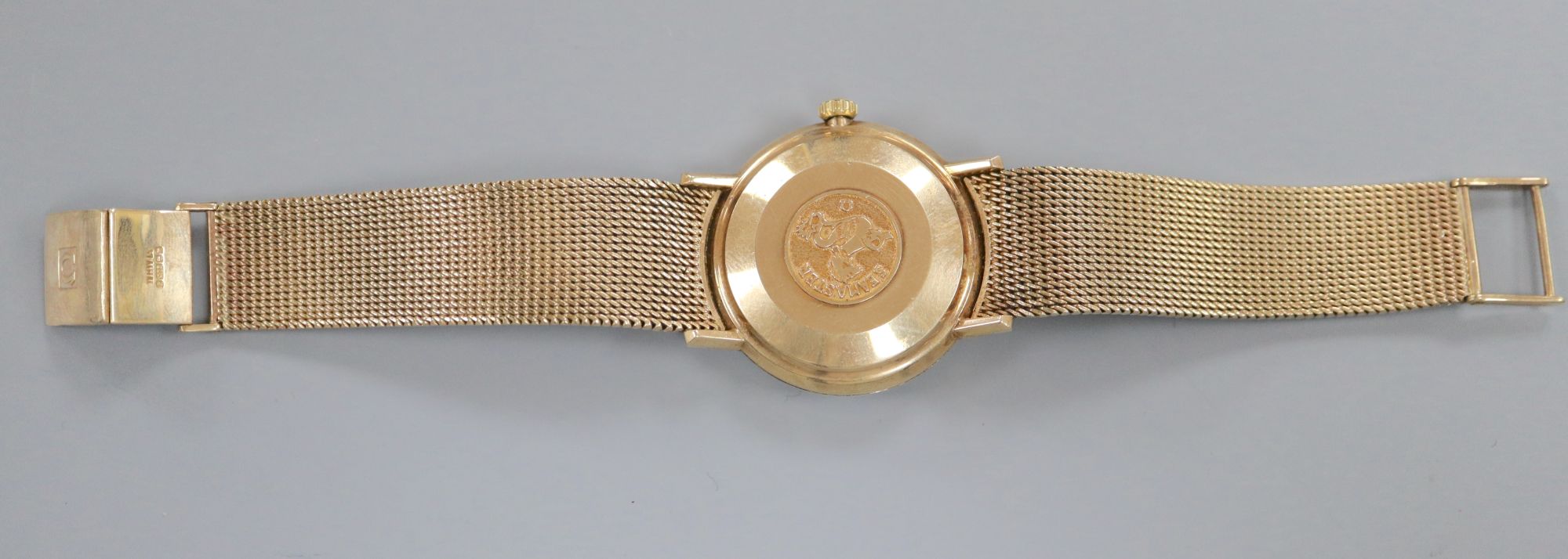 A gentlemans early 1970s 9ct gold Omega De Ville automatic wrist watch, on integral Omega 9ct gold bracelet,
